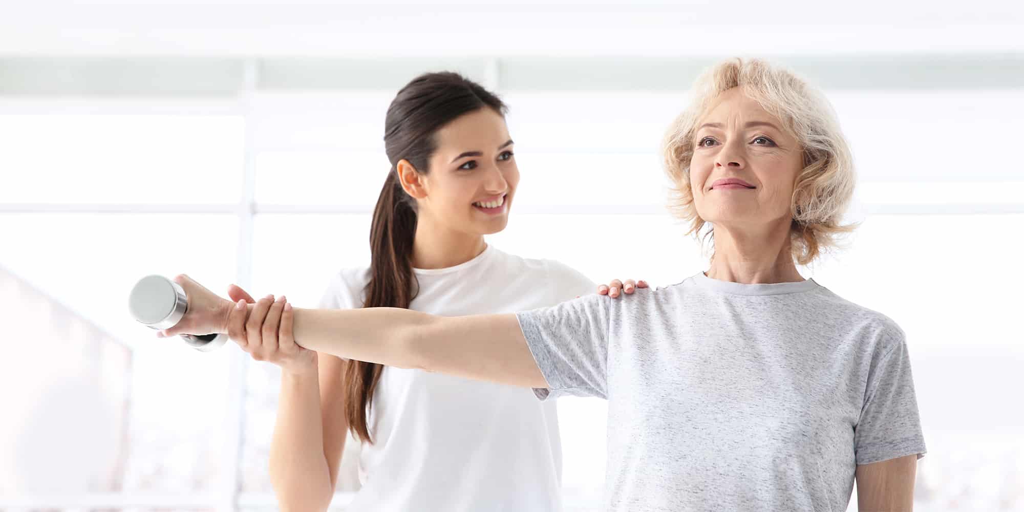 A senior participating in physical therapy practice, as someone may see when they visit. 